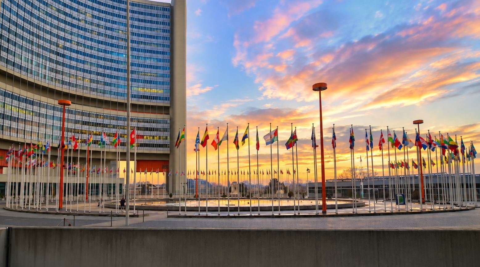 The Vienna International Centre at sunset, with member state flags in front